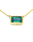 Emerald-cut emerald solitaire women's necklace east-west orientation handcrafted in 18k yellow gold