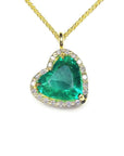Gold necklace with a heart-shaped emerald pendant on a white background