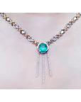 14K white and yellow gold Kisses and Hugs necklace with a square emerald pendant and diamond dangles.