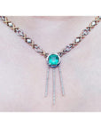 14K white and yellow gold Kisses and Hugs necklace with a square emerald pendant and diamond dangles.