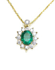 Front view of a gold necklace with an oval emerald in a halo diamond pendant on a white background