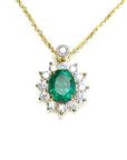 Front view of a gold necklace with an oval emerald in a halo diamond pendant on a white background