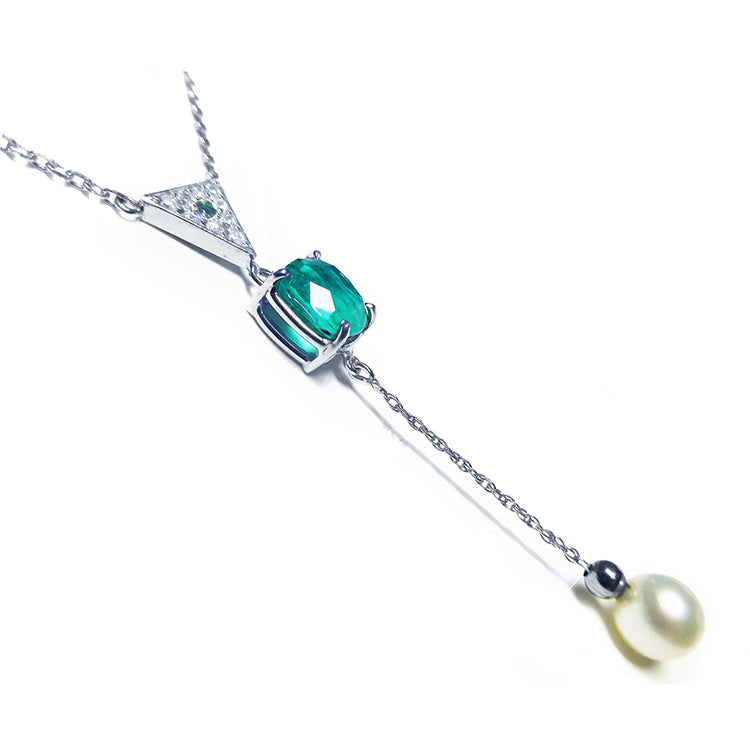 Emerald necklace cushion cut prong set in 14k white gold, dangling from a triangle shaped gold - fresh water pear dangling from the emerald