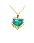 Gold necklace with a heart-shaped emerald pendant on a topside view position.