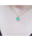 1.75 ct Colombian emerald pendant with diamond halo on a 14K gold chain.