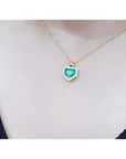 1.75 ct Colombian emerald pendant with diamond halo on a 14K gold chain.