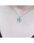 1.75 ct Colombian emerald pendant with diamond halo on a 14K gold chain.