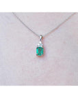 0.27 ct emerald pendant necklace with a vibrant green emerald and diamonds in 14K white gold.