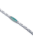 White gold bracelet with vibrant Colombian emeralds and princess-cut diamonds.