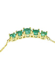 14K gold necklace with five round, medium green Colombian emeralds in elegant basket settings.