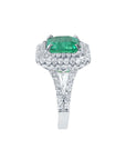 Natural halo diamond and colombian emerald ring for ladies in 14k white gold.