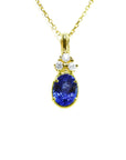 14K yellow gold pendant with an oval tanzanite and three round diamonds on a delicate chain.