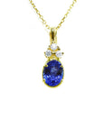 14K yellow gold pendant with an oval tanzanite and three round diamonds on a delicate chain.