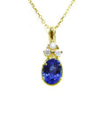 14K yellow gold pendant with an oval tanzanite and three round diamonds on a delicate chain.