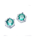 Diagonal top view position of pair of hexagonal halo diamond emerald stud earrings white gold.