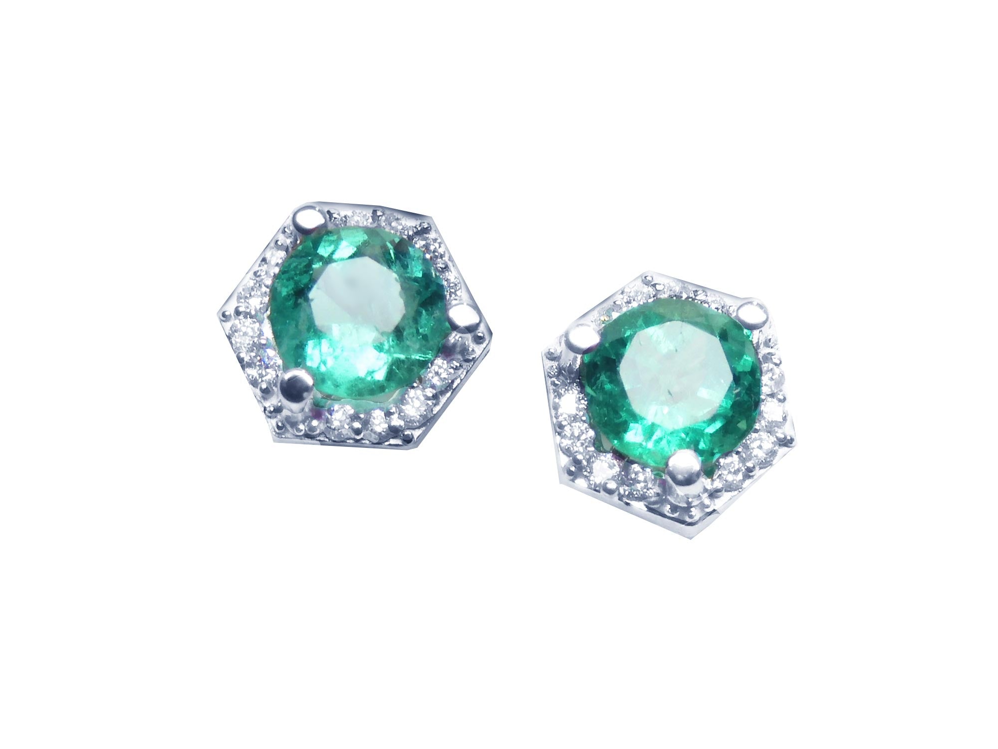 A pair of round cut Colombian emerald stud earrings with hexagonal halo of natural diamonds, set in 14K white gold.