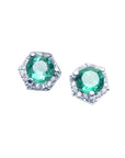 A pair of round cut Colombian emerald stud earrings with hexagonal halo of natural diamonds, set in 14K white gold.