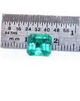 GIA certified 1.88 ct vibrant bluish-green Colombian emerald, shown next to a ruler for scale.