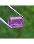 4.05 ct natural loose pink sapphire, emerald cut, held by tweezers.