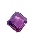 4.05 ct natural loose pink sapphire with an emerald cut, displaying vibrant purple hues.