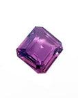 4.05 ct natural loose pink sapphire with an emerald cut, displaying vibrant purple hues.