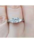 This GIA-certified radiant cut diamond ring features a 0.77 ct center stone and 0.47 ct trillion-cut All diamonds are natural and prong-set in 14k white gold.