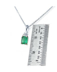 0.27 ct emerald necklace pendant in 14K white gold, shown next to a ruler for size.