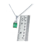 0.27 ct emerald necklace pendant in 14K white gold, shown next to a ruler for size.