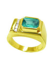 Men's 14K yellow gold ring with an east-west emerald-cut Colombian emerald and channel-set accent diamonds.