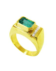 Men's 14K yellow gold ring with an east-west emerald-cut Colombian emerald and channel-set diamonds.