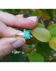 14K gold ring with a rectangular emerald-cut emerald and tapered baguette side diamonds.