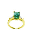 14K gold ring with a rectangular emerald-cut emerald and tapered baguette side diamonds.