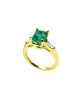 14K gold ring with a rectangular emerald-cut emerald and tapered baguette side diamonds.