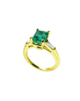 14K gold ring with a rectangular emerald-cut emerald and tapered baguette side diamonds.