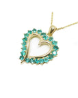14K gold heart pendant necklace with vibrant round Colombian emeralds.