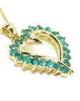 Gold heart-shaped pendant with round emerald gemstones on a side profile view.