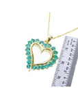 1.42 ct. emerald heart pendant necklace with 14K gold chain, shown with ruler for size.