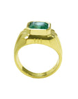 Men's gold ring with a square colombian emerald on a lateral profile side view.