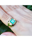 18K yellow gold men's solitaire ring with a square emerald-cut Muzo Colombian emerald in a full bezel setting.