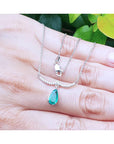 Pear cut necklace natural Colombian emerald dangling from a wavy central bar with diamonds pave set in 14k white gold