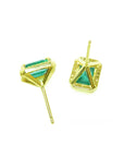 A pair of yellow gold earrings with genuine emeralds upside down for an underside view