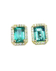 Pair of rectangular emerald stud earrings, in a halo diamond made of yellow gold.