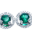 Pair of halo diamond emerald stud earrings, top view on a front position
