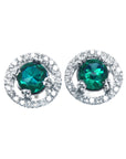 Pair of halo diamond stud earrings with natural Muzo Colombia emeralds, on a top view.