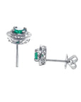 1.06 ct deep bluish-green emerald stud earrings in 14K white gold with diamond halo and screw backs.