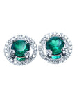 Pair of halo diamond and natural colombian emerald stud earrings in 14k white gold.