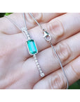 Women's 14K white gold necklace with a rectangular Colombian emerald and diamond accents.