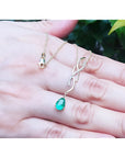 14K yellow gold twisted slider necklace with a medium deep green pear-shaped emerald pendant.