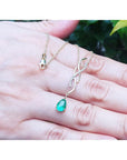 14K yellow gold twisted slider necklace with a medium deep green pear-shaped emerald pendant.