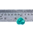 1.26 ct. heart cut Colombian emerald with vibrant bluish-green color, shown next to a ruler for scale.